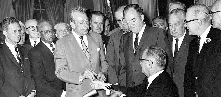 At the signing ceremony for the Civil Rights Act of 1964, President Lyndon Johnson hands one of the pens he used to Senator Everett Dirksen.