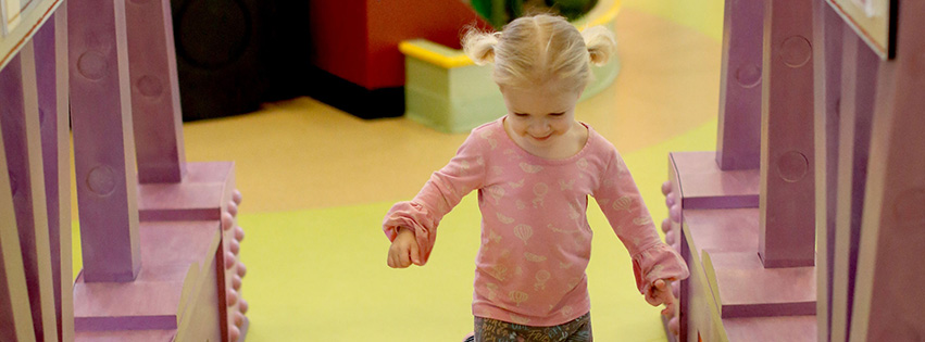 Young girl playing at the Peoria PlayHouse Children's Museum