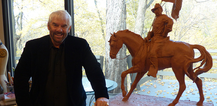 Lonnie Stewart and his preliminary model of President Theodore Roosevelt