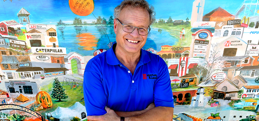 Man in front of a mural of Morton, Illinois