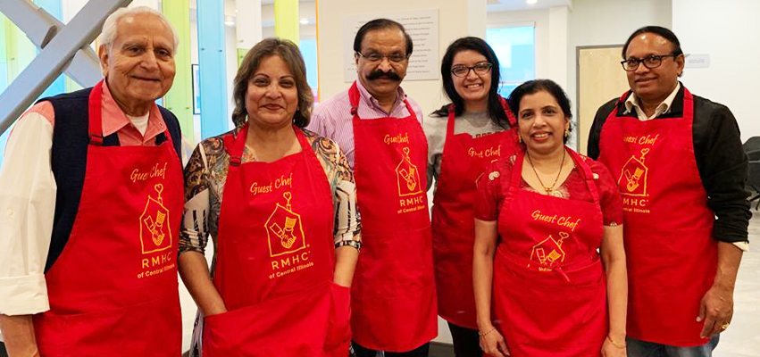 A group of people in Red aprons