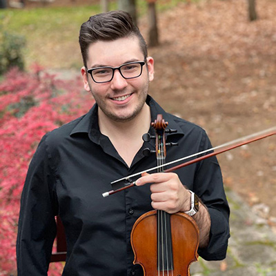 Young man holding a violin.