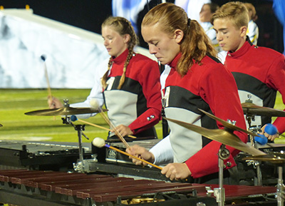 Marching band members playing xylophones