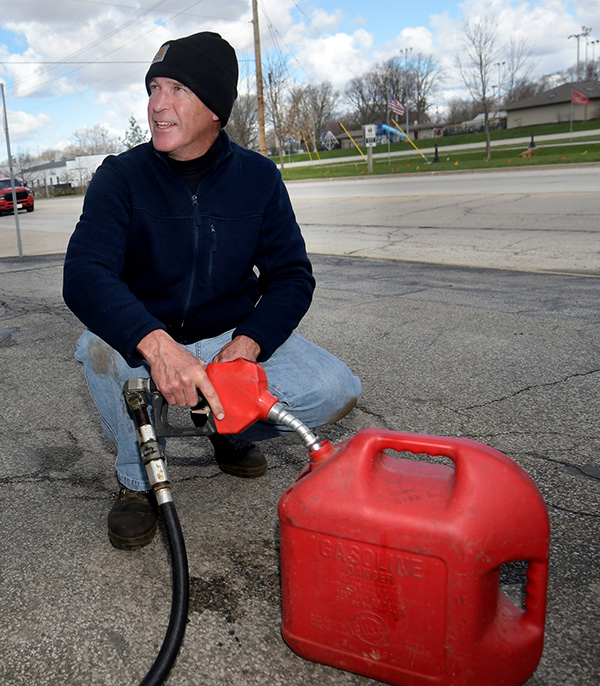 Tom Gibson, the third Generation, pumps gas