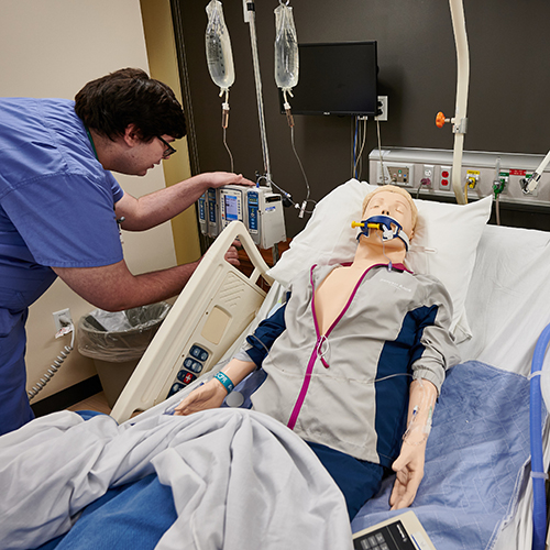 A student prepares medication for administration.