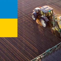 Farm Tractor on field and a Ukraine flag