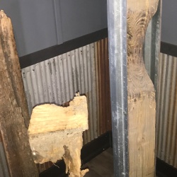 Rotted wooden posts (left) are shown next to a post reinforced with a column repair sleeve, a patented product at Savage Building Systems in Varna
