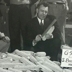 Archive photo of Ev Dirksen and other looking at ears of test corn