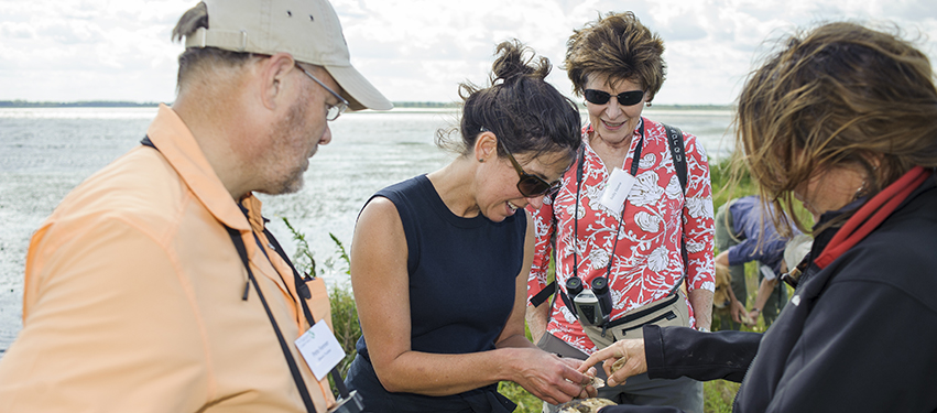 TNC State Director Michelle Carr inspects mussels discovered by TNC Aquatic Biologist Maria Lemke at Emiquon National Wildlife Refuge