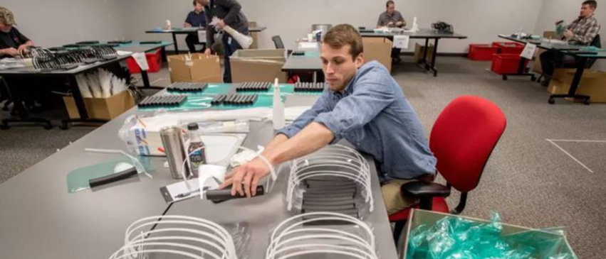 ATS employee working on producing face shields