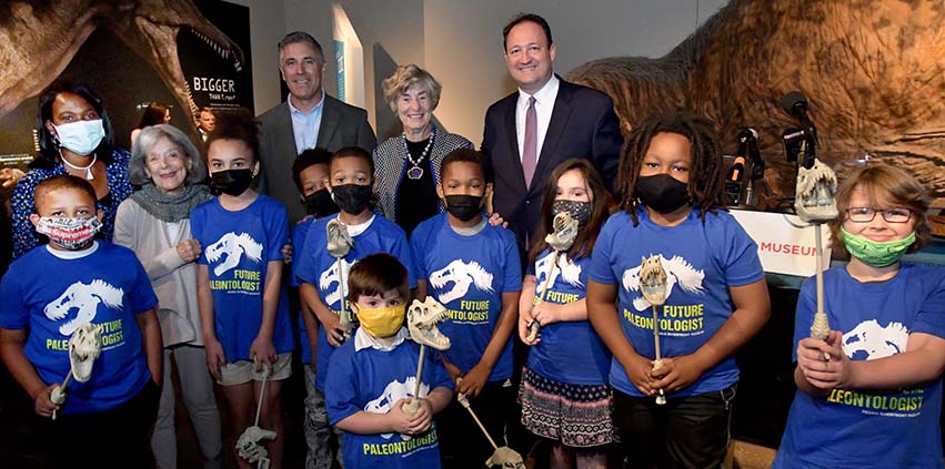 Above: Peoria Riverfront Museum CEO John Morris with Dr. Sharon Kherat, Zan Ransburg, Matt Mamer, Sally Snyder and students were invited for the official dedication of the T.rex exhibition.