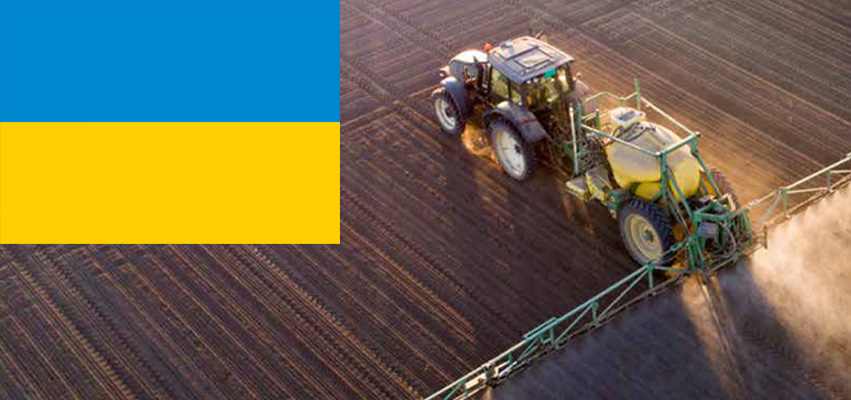 Farm Tractor on field and a Ukraine flag