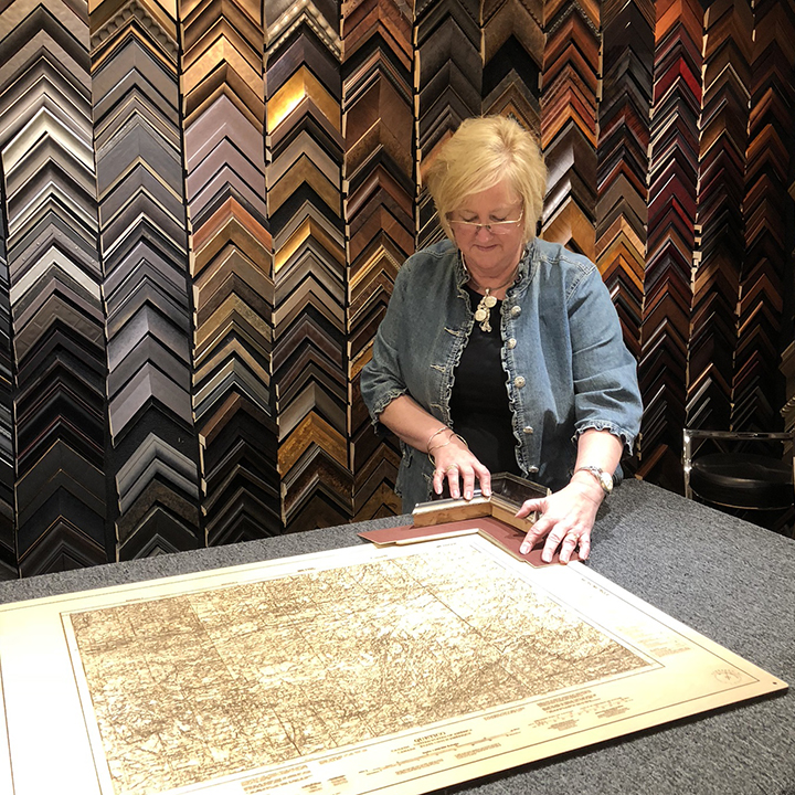 Exhibit A Gallery owner Barb Milaccio has framed a wide-ranging assortment of items over the years, from sports jerseys and military clothing to wedding dresses, Caterpillar pins, guitars and more.