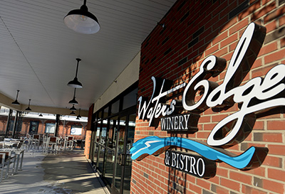 Waters Edge Winery & Bistro Sign in front of business