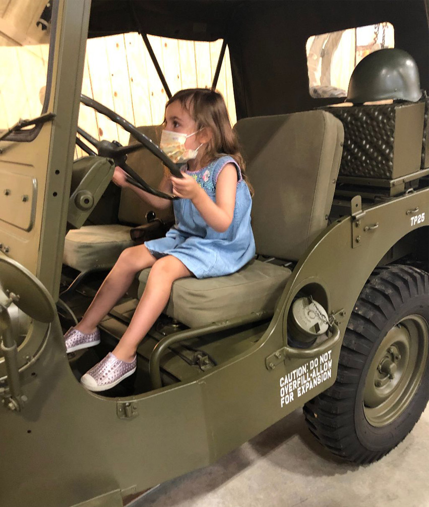 child steering on the restored 1952 Army jeep