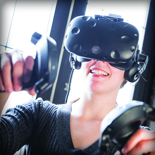 A woman using a virtual reality headset and controls
