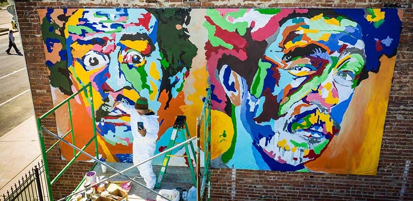 André Petty working on his mural of Richard Prior in downtown Peoria
