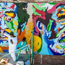 André Petty working on his mural of Richard Prior in downtown Peoria